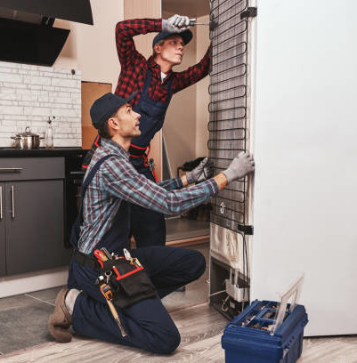 Origin Refrigeration technician repairing an appliance on site